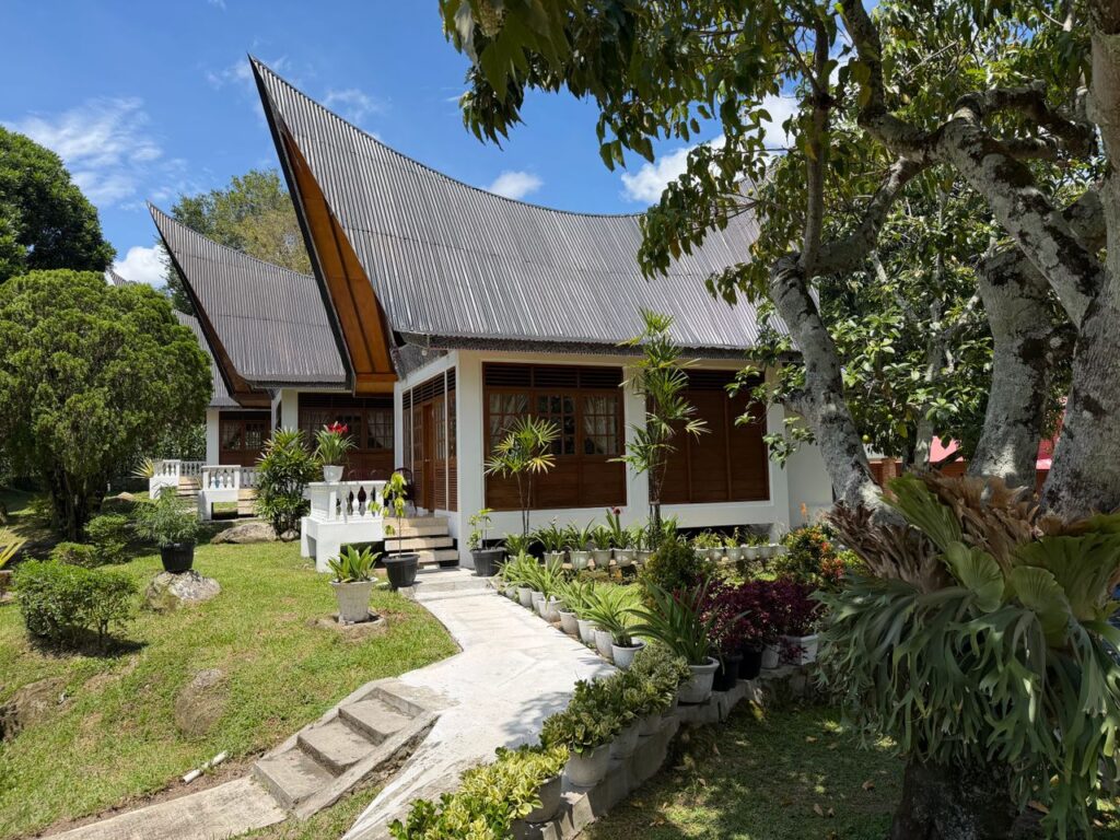 Charming traditional Batak architecture surrounded by lush greenery in Indonesia